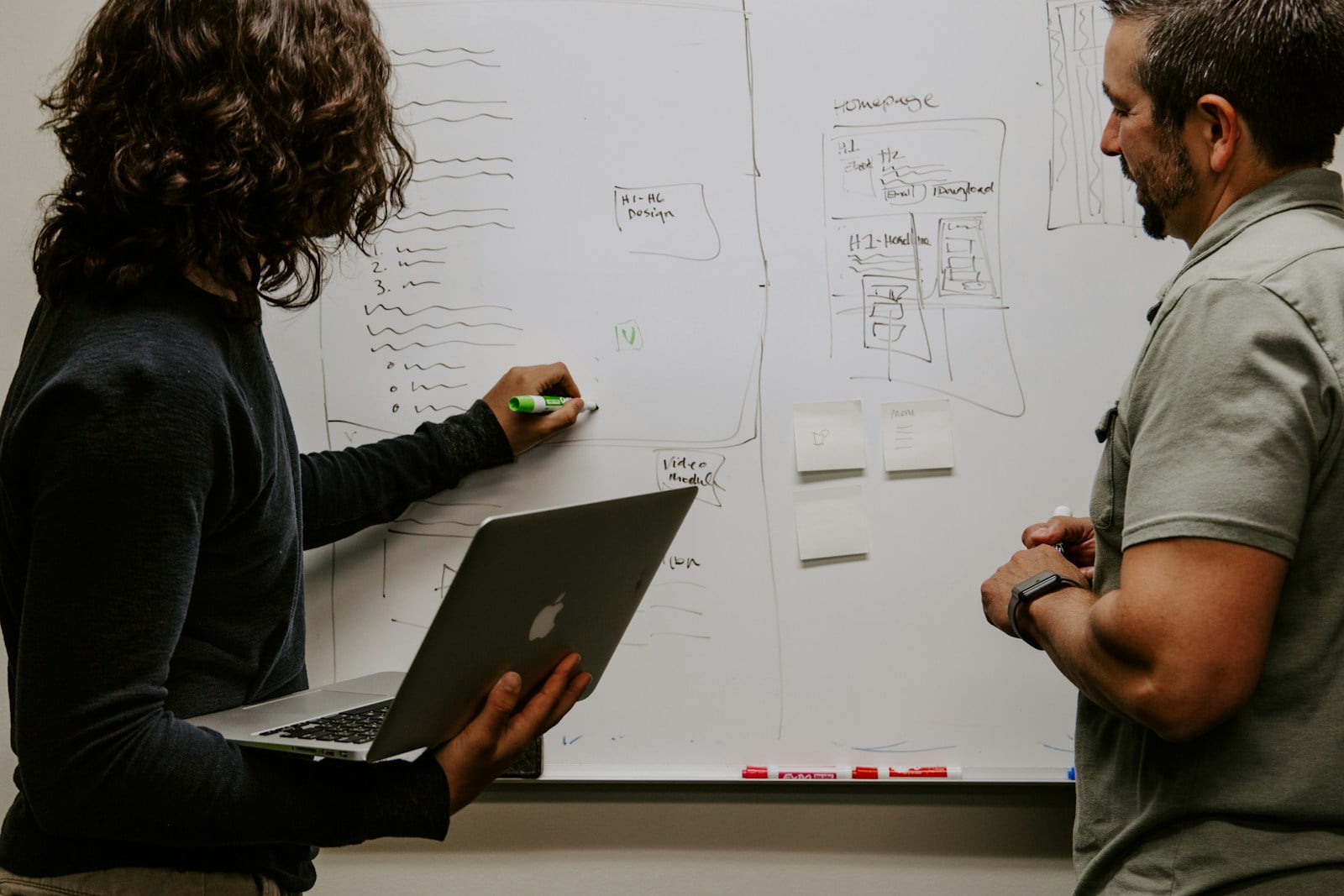 Photo by Kaleidico man wearing gray polo shirt beside dry-erase board