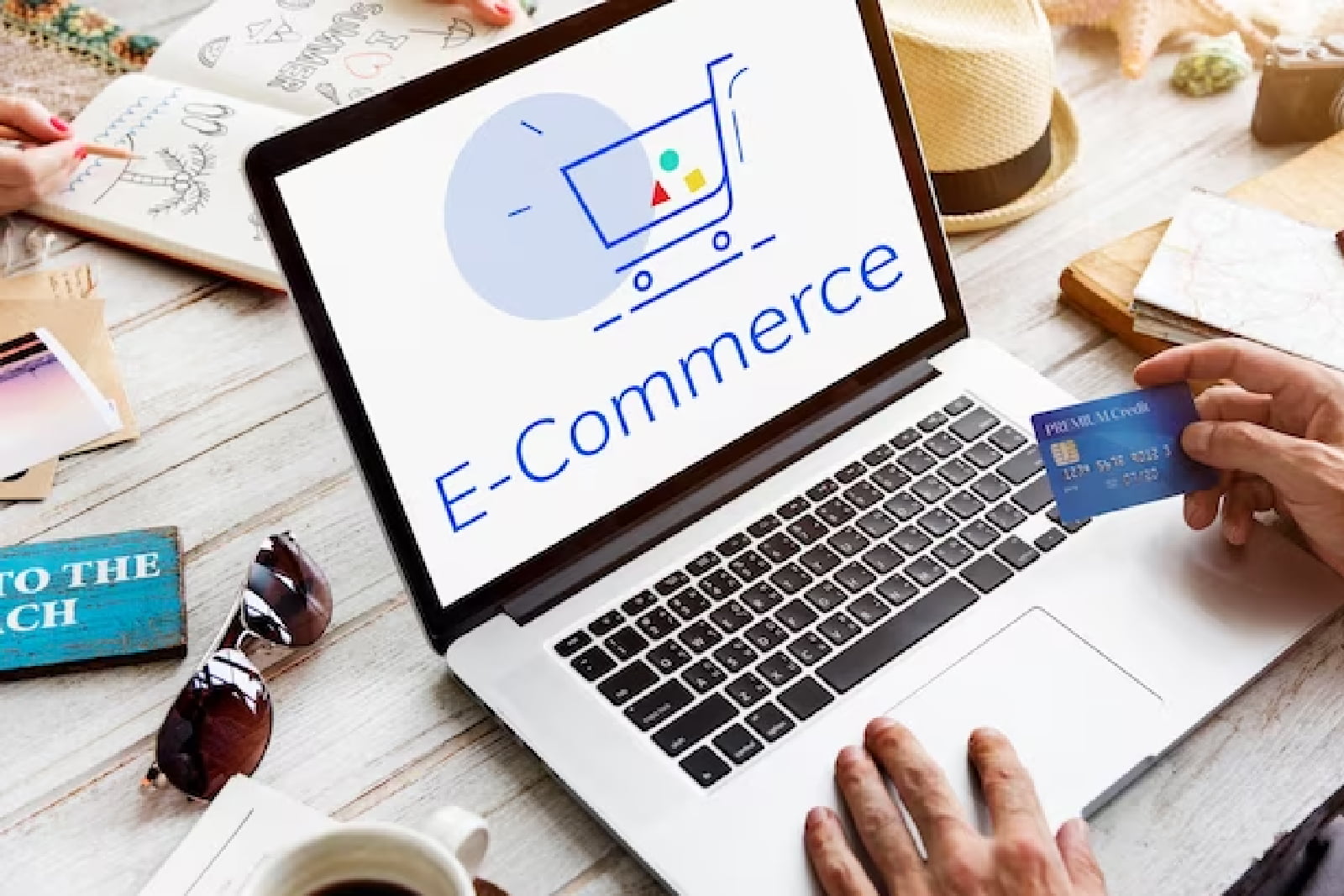 e commerce MacBook Air beside gold-colored study lamp and spiral books