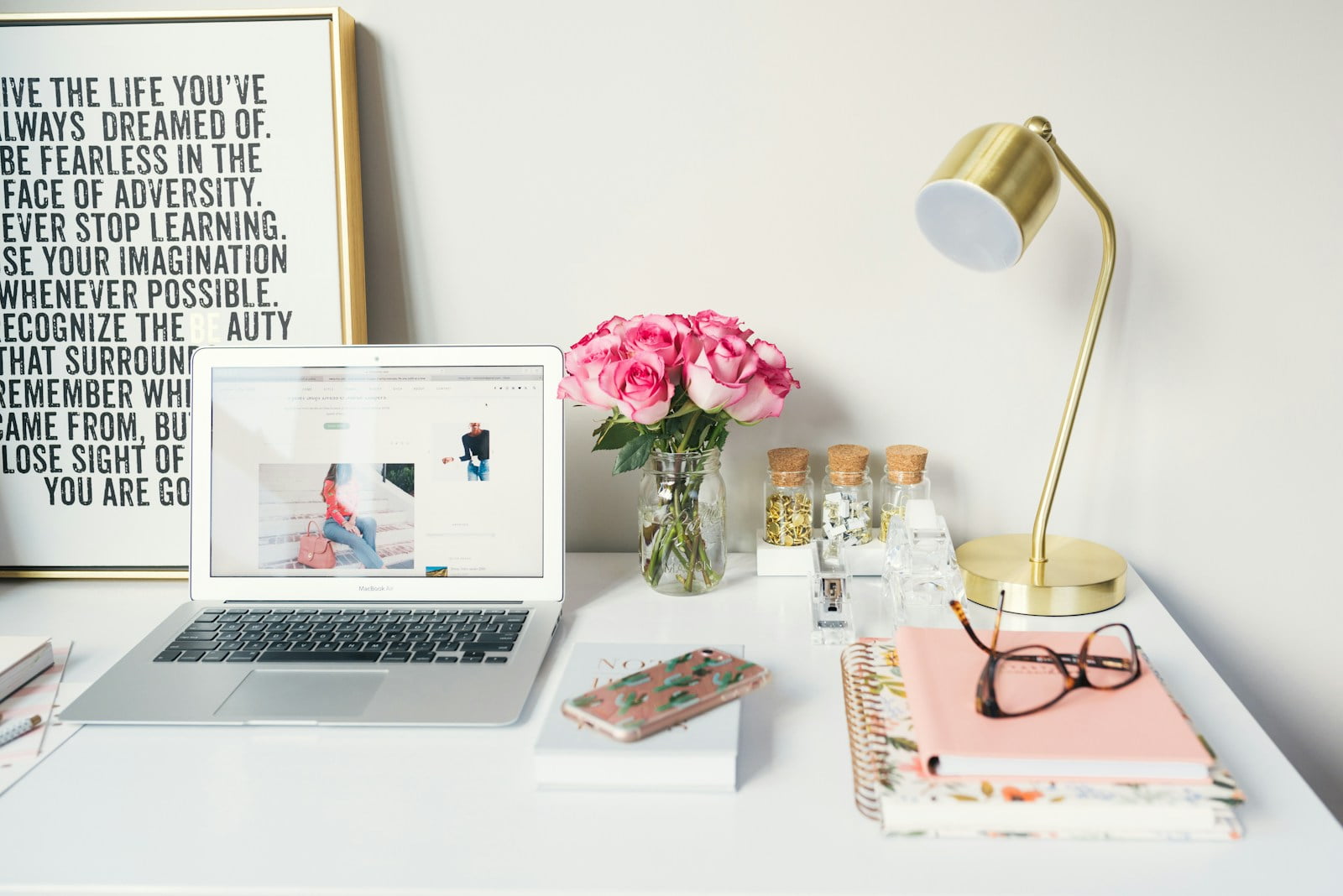 Photo by Arnel Hasanovic MacBook Air beside gold-colored study lamp and spiral books